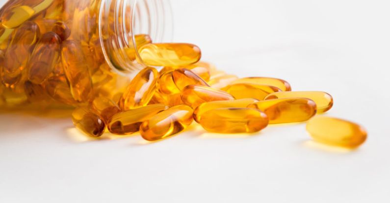 Fish Oil - Spilled Bottle of Yellow Capsule Pills